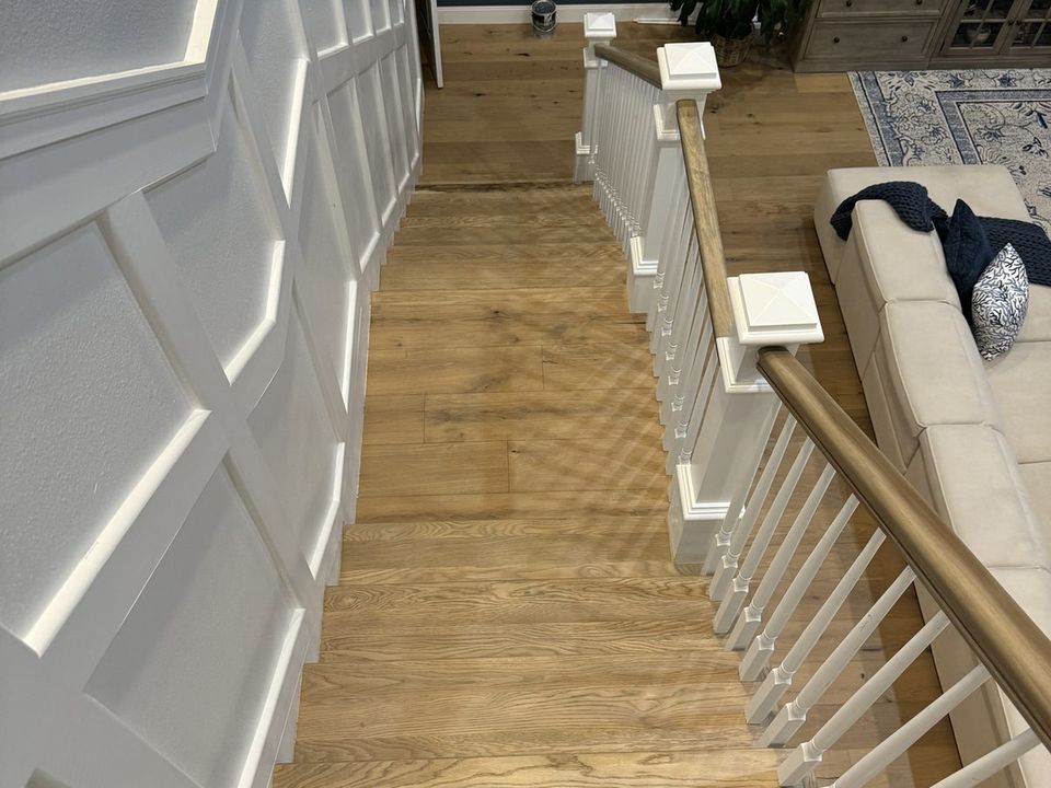 Stair treads being installed as part of a flooring project on the Gulf Coast